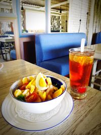 Close-up of fruits with drink on table