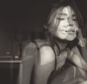 Portrait of young woman sitting at home
