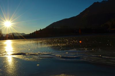 Scenic view of lake against sky at sunset