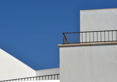 Low angle view of steps against clear blue sky