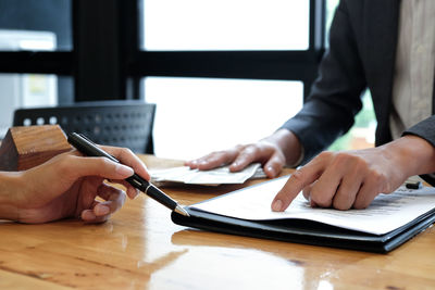Midsection of man working on table