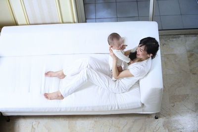 Couple sitting on bed