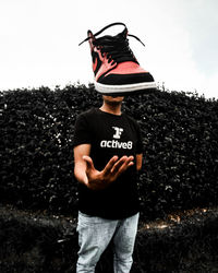 Man wearing hat standing against sky