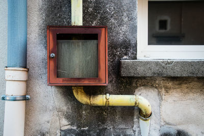 Close-up of old machine part of building