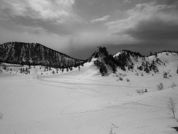 Scenic view of snow covered mountains against sky