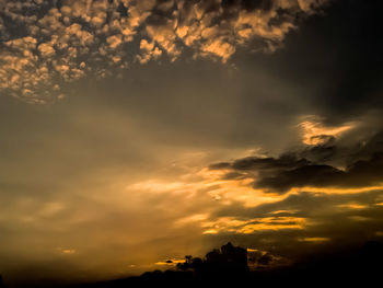 Low angle view of dramatic sky during sunset