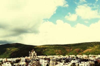 High angle view of town against cloudy sky