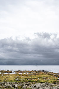 Sailboat and thunder clouds at svaneke, bornholm, denmark