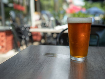 Close-up of beer glass on table