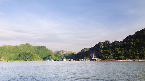 Scenic view of sea and mountains against sky