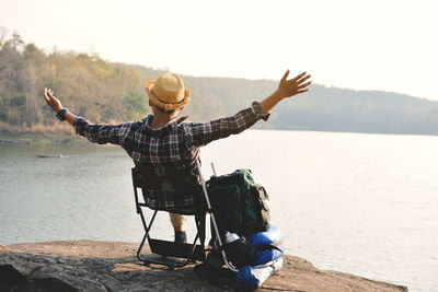 Man sitting by lake 