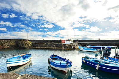 Boats moored in sea against sky