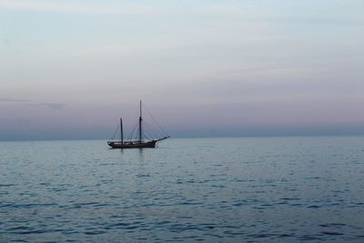 Sailboat sailing on sea against sky