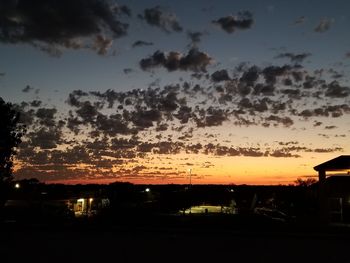 Silhouette trees against sky at night
