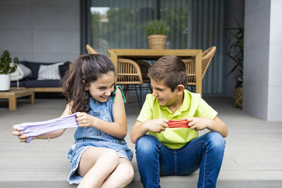 Happy friends sitting outdoors