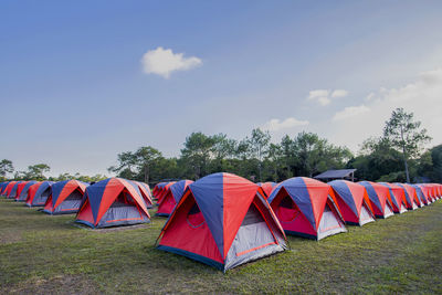 Multi colored tent on field against sky