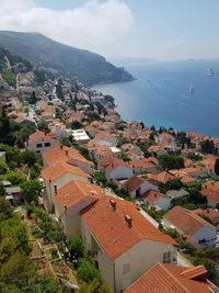 High angle view of townscape by sea against sky