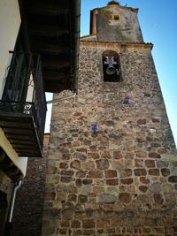 Low angle view of bell tower against sky