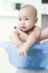 Portrait of shirtless boy in bathroom