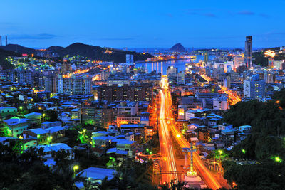 High angle view of city lit up at night