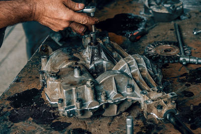 Cropped image of man working on barbecue grill