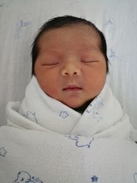 Portrait of cute boy sleeping in bed