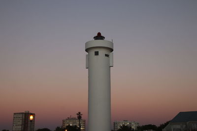 Low angle view of lighthouse against sky during sunset