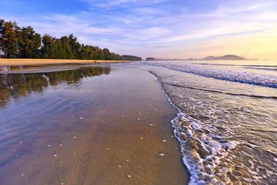 Scenic view of beach against sky during sunset