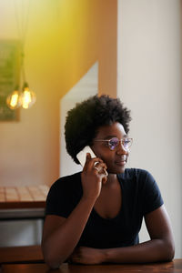 Portrait of young woman sitting at home