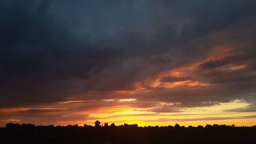 Silhouette landscape against dramatic sky