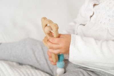 Cropped hand of woman holding dentures