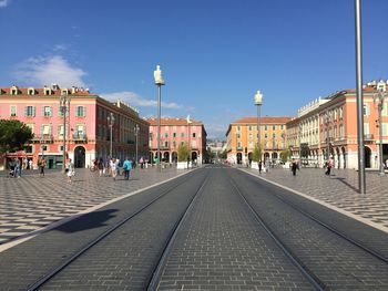 View of city street against blue sky