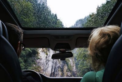 Rear view of couple traveling in car