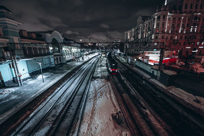 Train on railroad tracks in city during winter