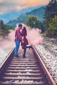 Full length of woman on railroad track against sky