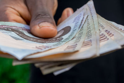 Close-up of hand holding paper