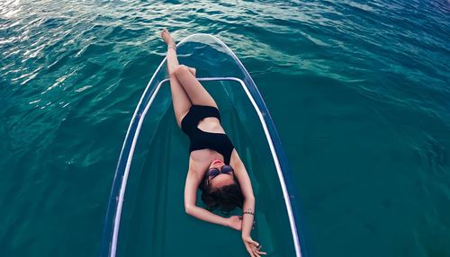 High angle view of woman swimming in sea