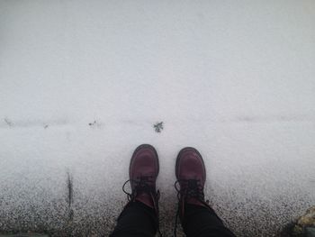 Low section of person standing in the dark