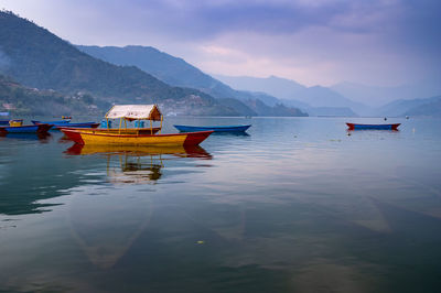 Boat in lake against sky