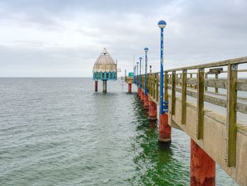 Pier over sea against sky
