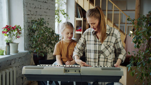 Young woman using laptop while sitting at home