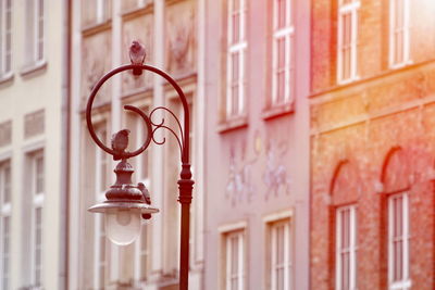 Close-up of street light against buildings