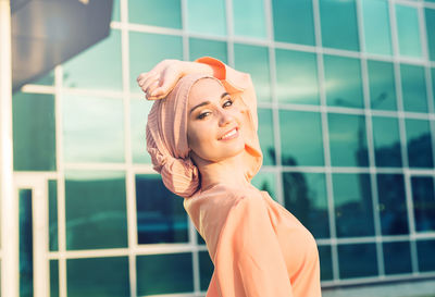 Portrait of smiling young woman standing outdoors