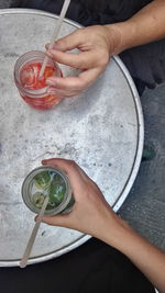 Low section of persons holding cocktails