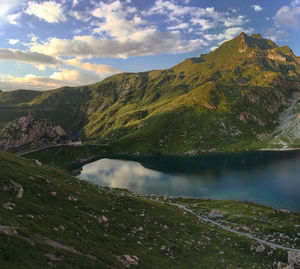 Scenic view of lake and mountains against sky