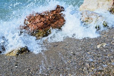 Waves splashing on rocks at shore