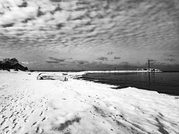 Scenic view of beach against sky during winter