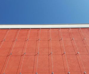 Red roof against brick wall