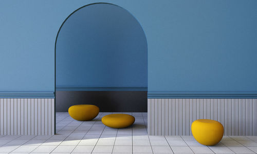 Fruits on table against blue wall