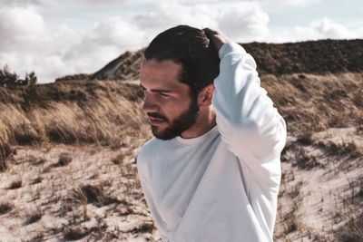 Young man standing at beach